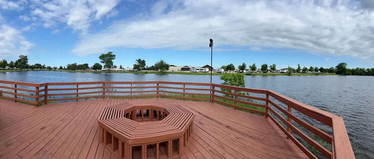 Wood deck and railing overlooking a pond